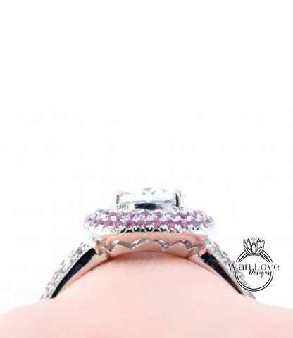 A close-up view of a diamond ring with a large central diamond surrounded by smaller diamonds, set in a silver band with a pinkish hue.