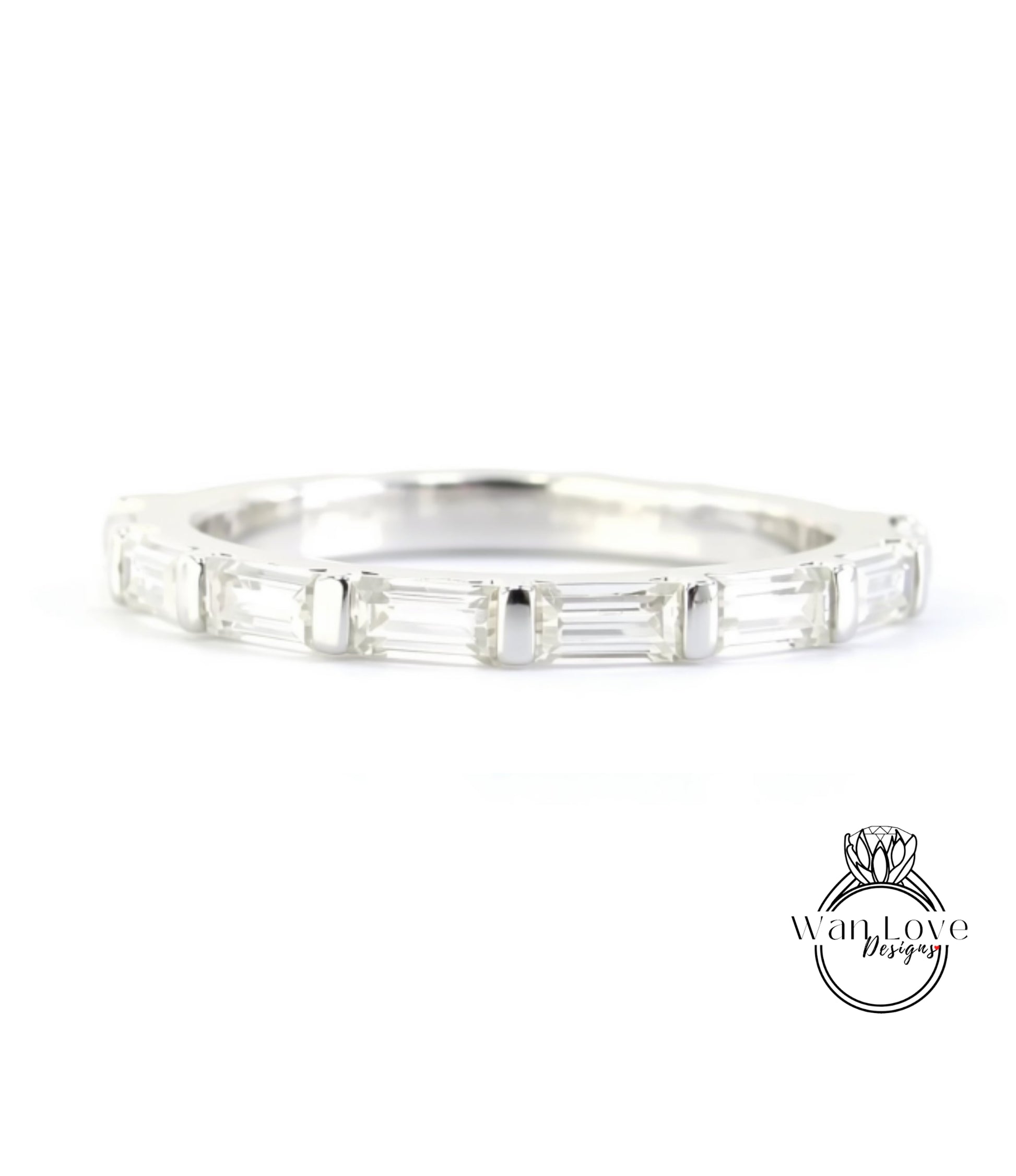 A silver band ring with a row of clear gemstones, likely diamonds, set in a simple and elegant design.