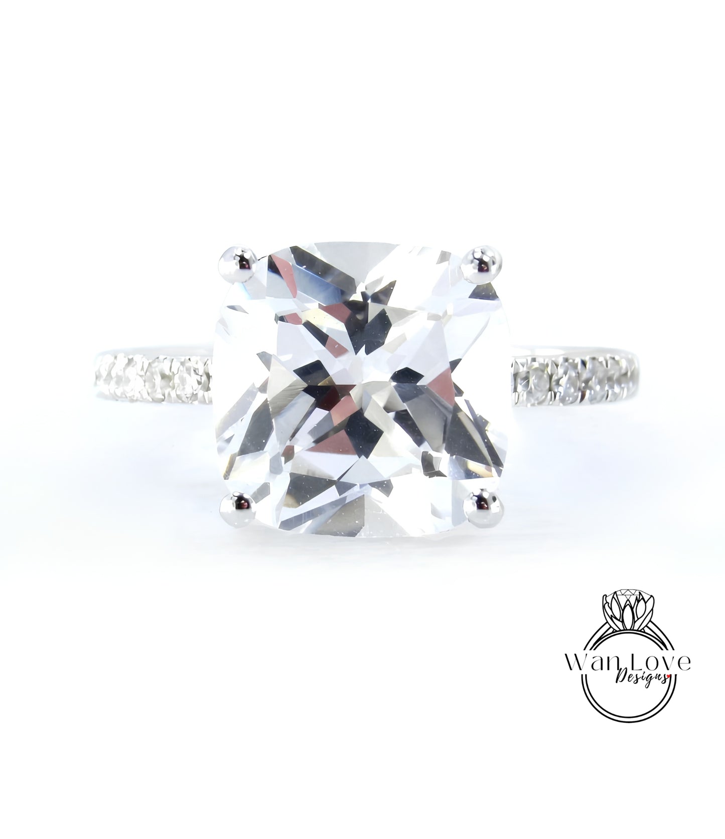 A large, clear gemstone ring with a diamond band, showcasing the intricate details and sparkle of the diamonds.