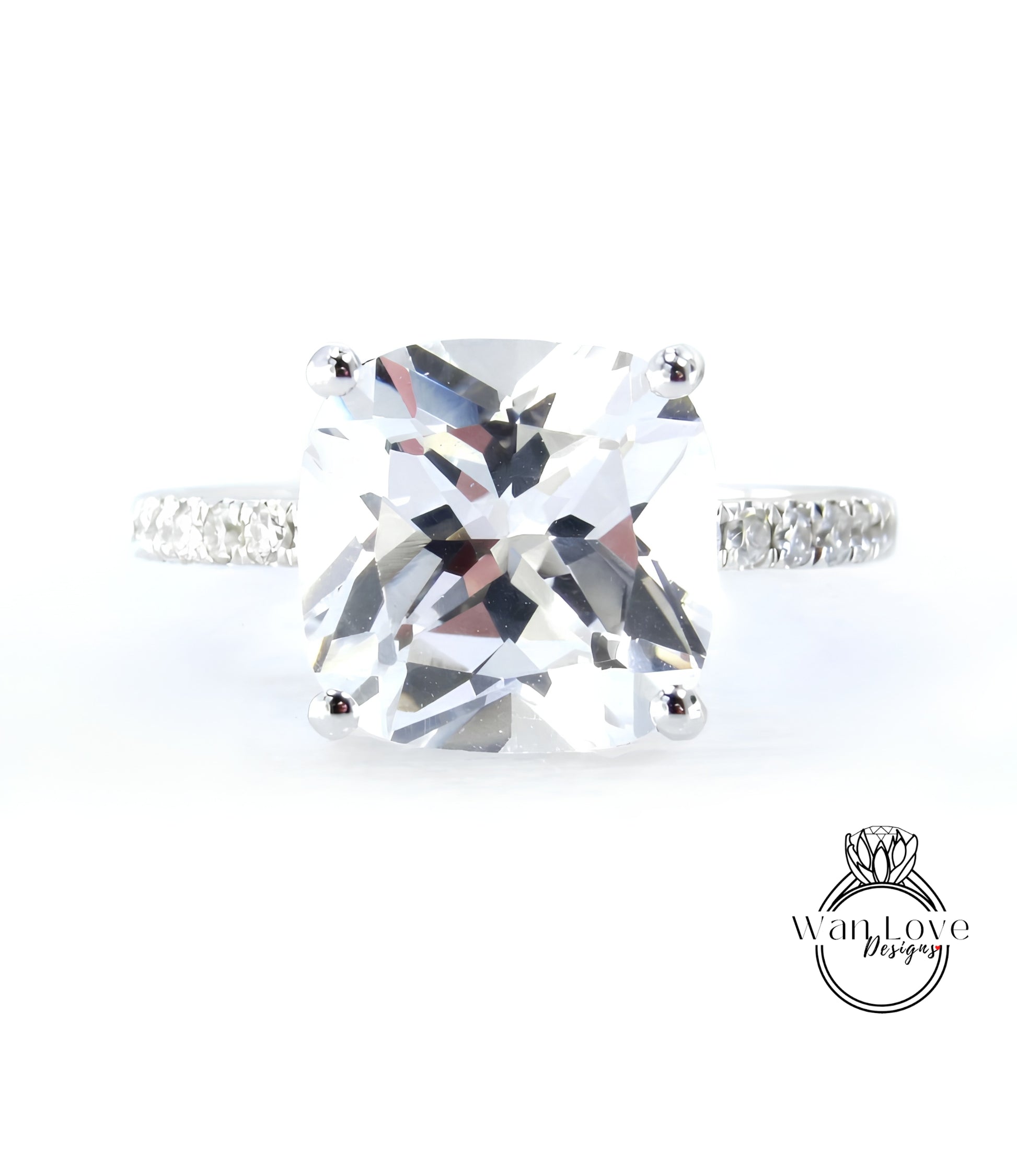 A large, clear gemstone ring with a diamond band, showcasing the intricate details and sparkle of the diamonds.