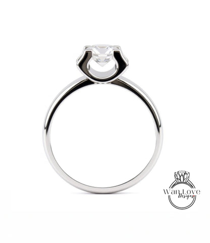 A silver engagement ring with a large central diamond.