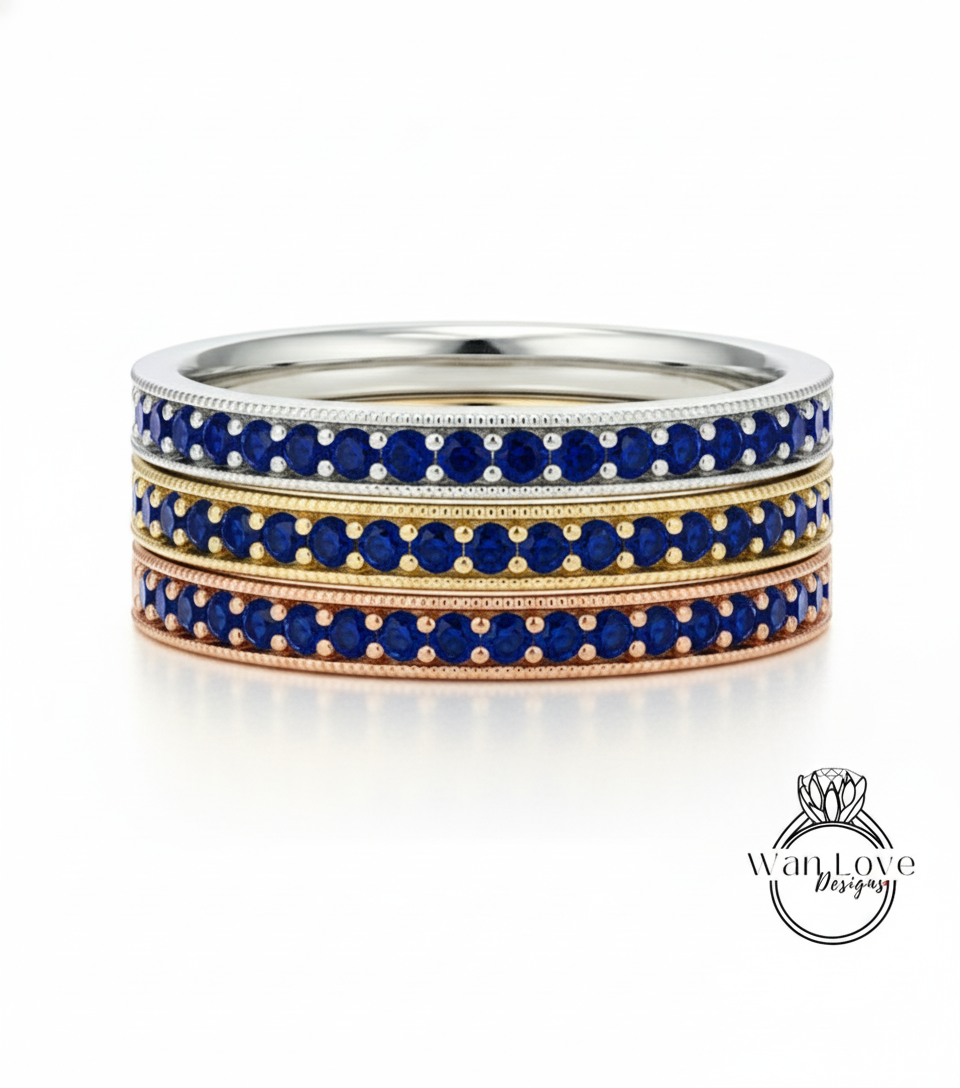 A stack of three rings with blue gemstones set in a metallic band.