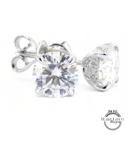 A pair of elegant silver earrings with large, clear diamonds set in the center.