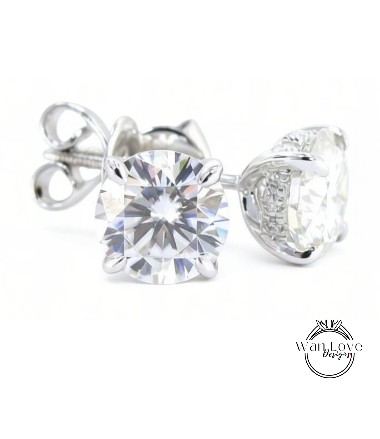 A pair of elegant silver earrings with large, clear diamonds set in the center.