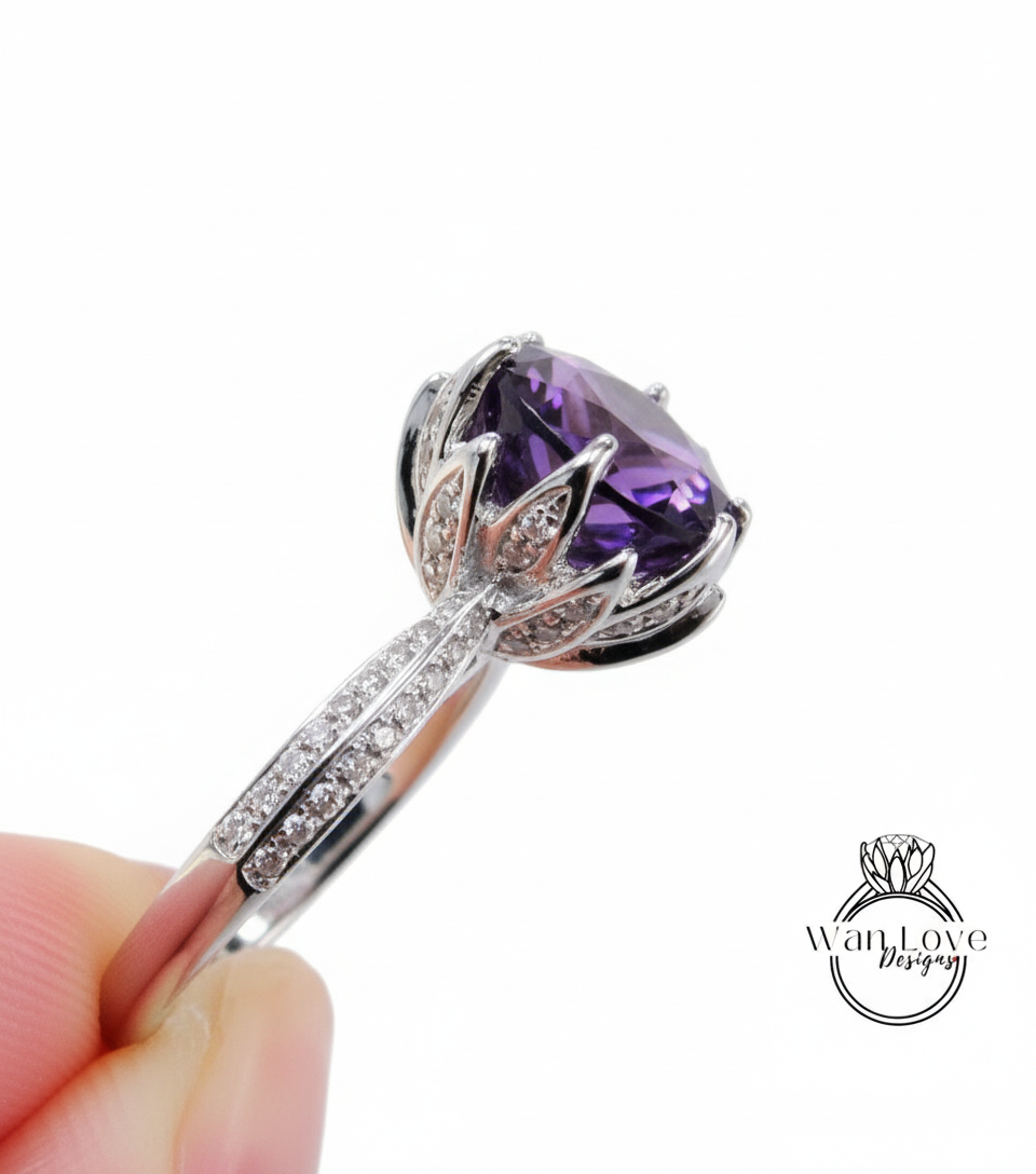 A close-up image of a silver ring with a large purple gemstone, possibly an amethyst, surrounded by smaller diamonds.