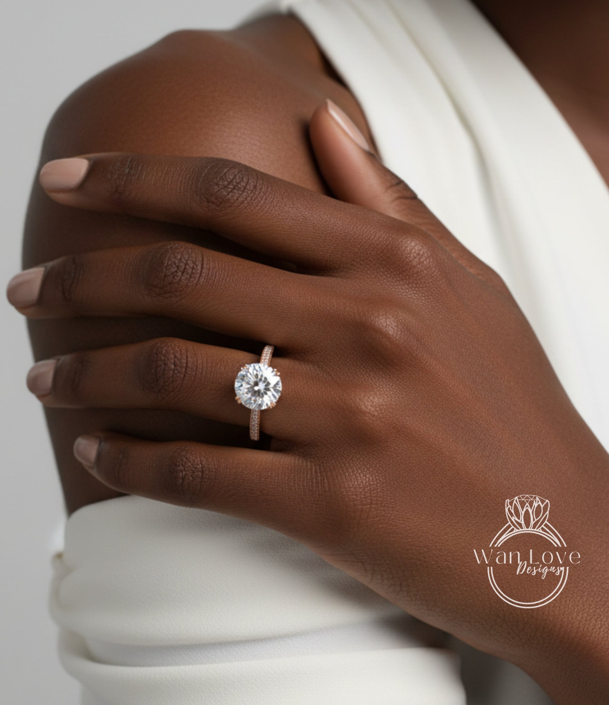 A close-up of a person's hand wearing a large, round diamond engagement ring on the ring finger.