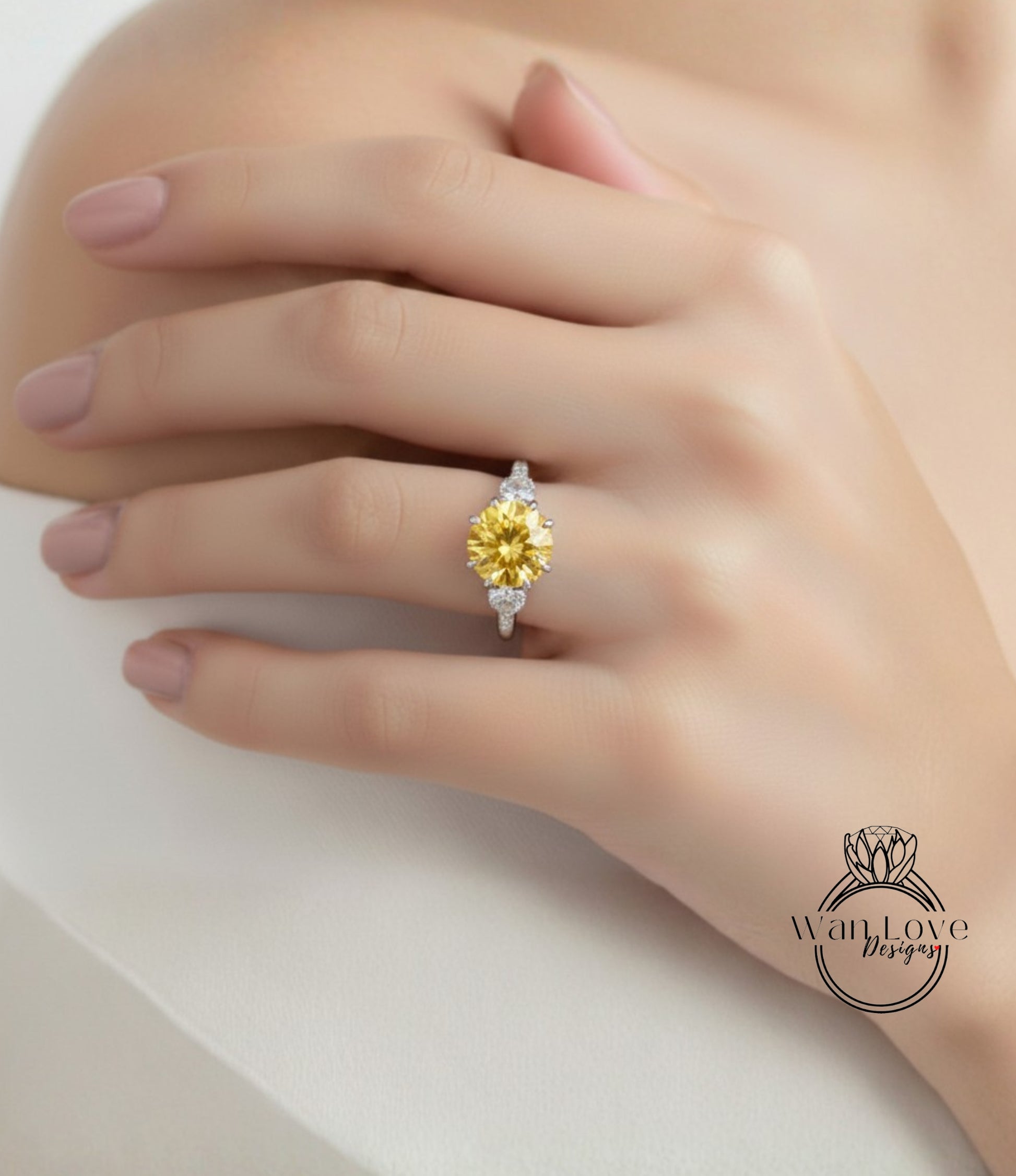 A close-up of a hand wearing a yellow diamond ring with a large center stone.
