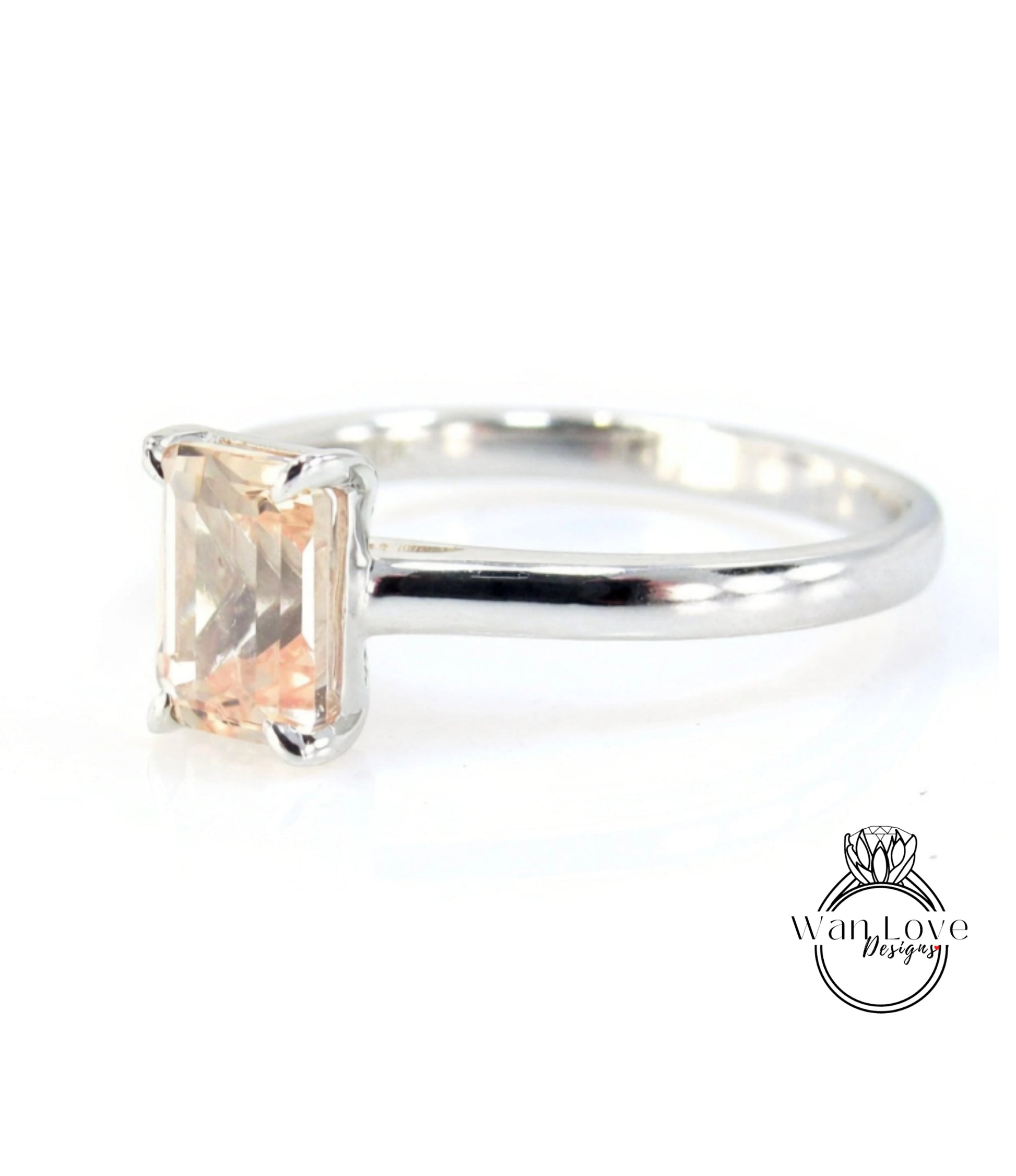 A silver engagement ring with a large, rectangular-shaped gemstone set in the band.