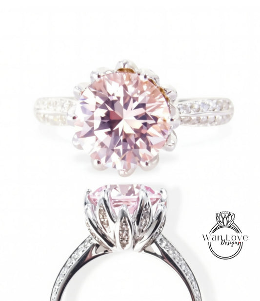 A close-up of a beautiful pink diamond ring with a large central diamond surrounded by smaller diamonds on the band.