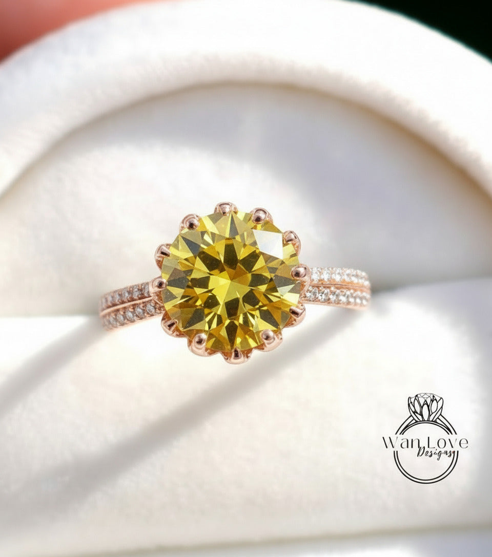 A close-up image of a yellow diamond ring with a large center stone surrounded by smaller diamonds on the band.