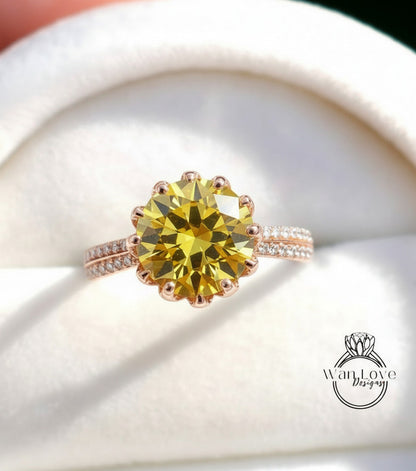 A close-up image of a yellow diamond ring with a large center stone surrounded by smaller diamonds on the band.