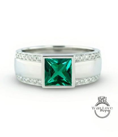 A silver ring with a large square emerald gemstone in the center, surrounded by smaller diamonds.