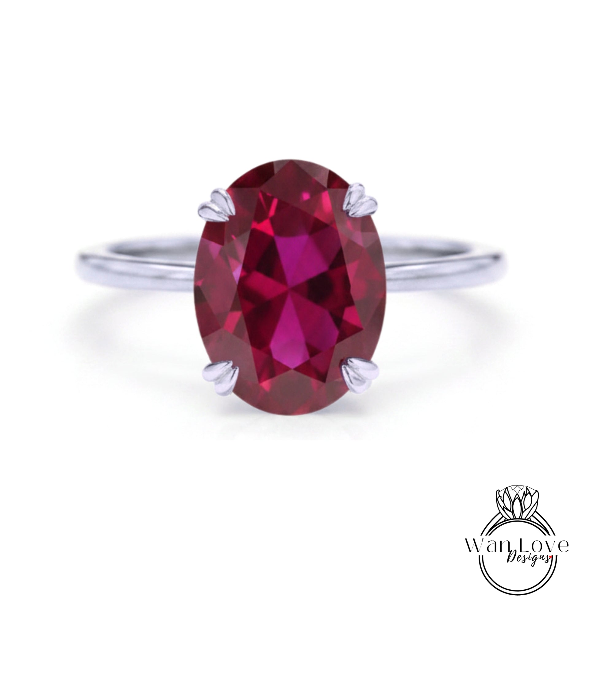 A close-up image of a ring with a large, deep red gemstone, likely a garnet, set in a silver band.