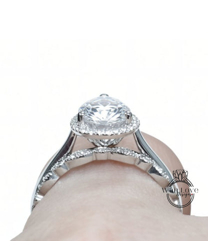 A close-up view of a diamond engagement ring on a person's hand.