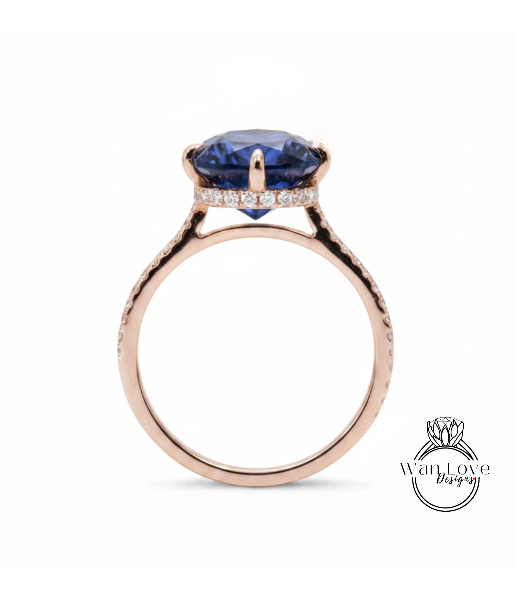 A rose gold ring with a large blue gemstone set in the center, surrounded by smaller diamonds.