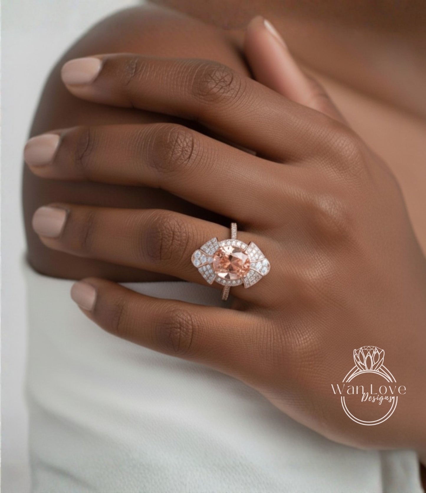 A close-up of a person's hand wearing a large, ornate ring with a pink gemstone.