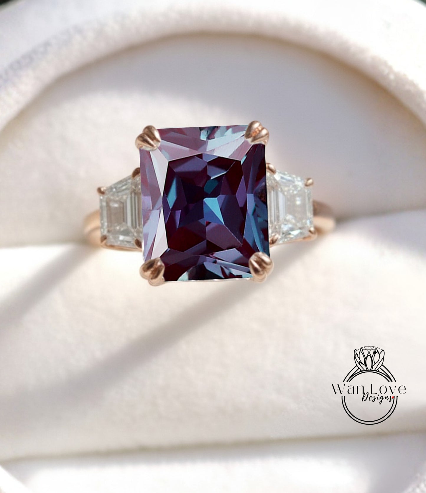 A close-up image of a gold ring with a large, deep purple gemstone set in the center, surrounded by smaller diamonds.
