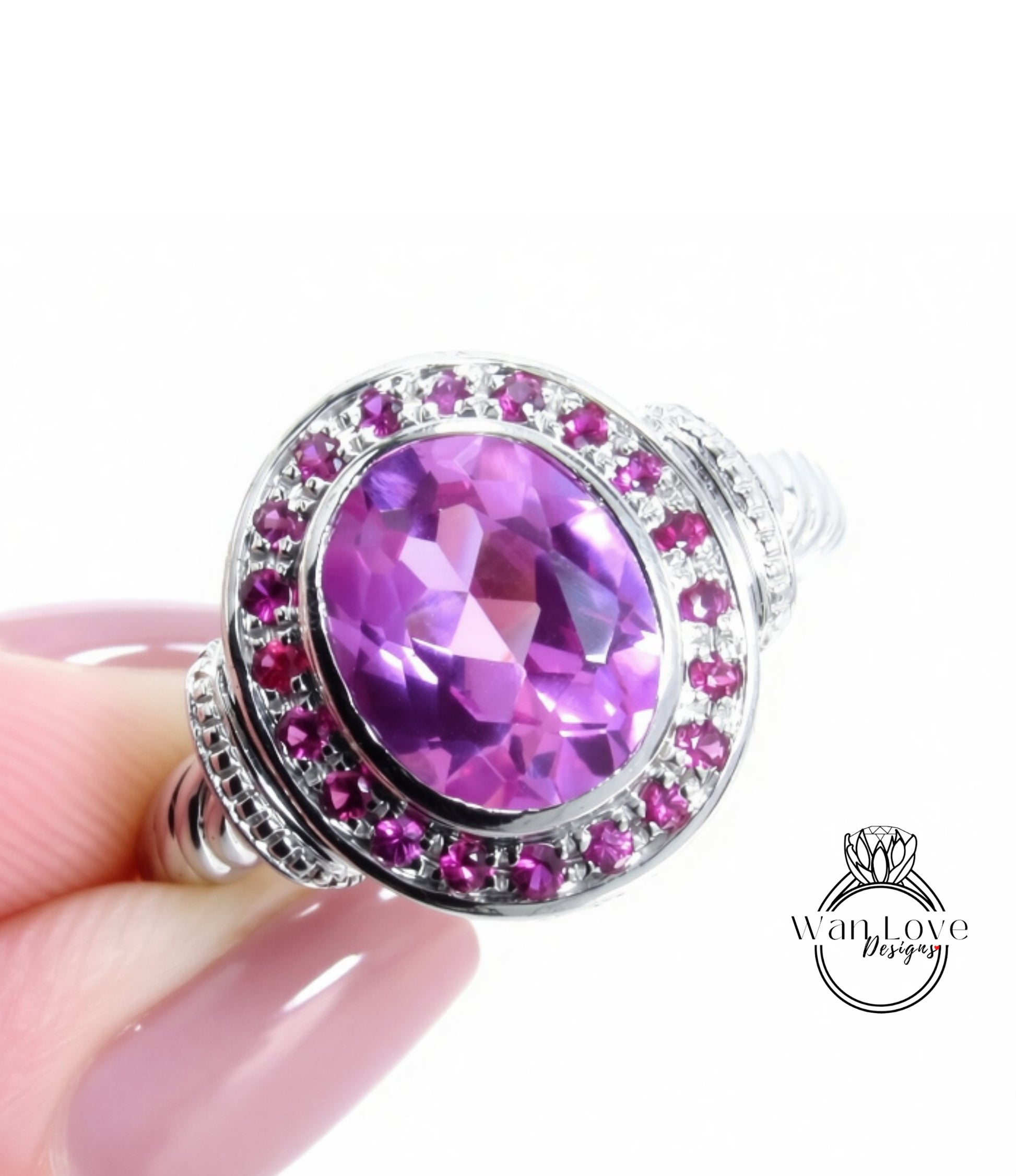 A close-up image of a person's hand holding a ring with a large oval-shaped purple gemstone surrounded by smaller purple gemstones.