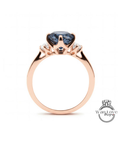 A rose gold ring with a large blue gemstone set in the center.