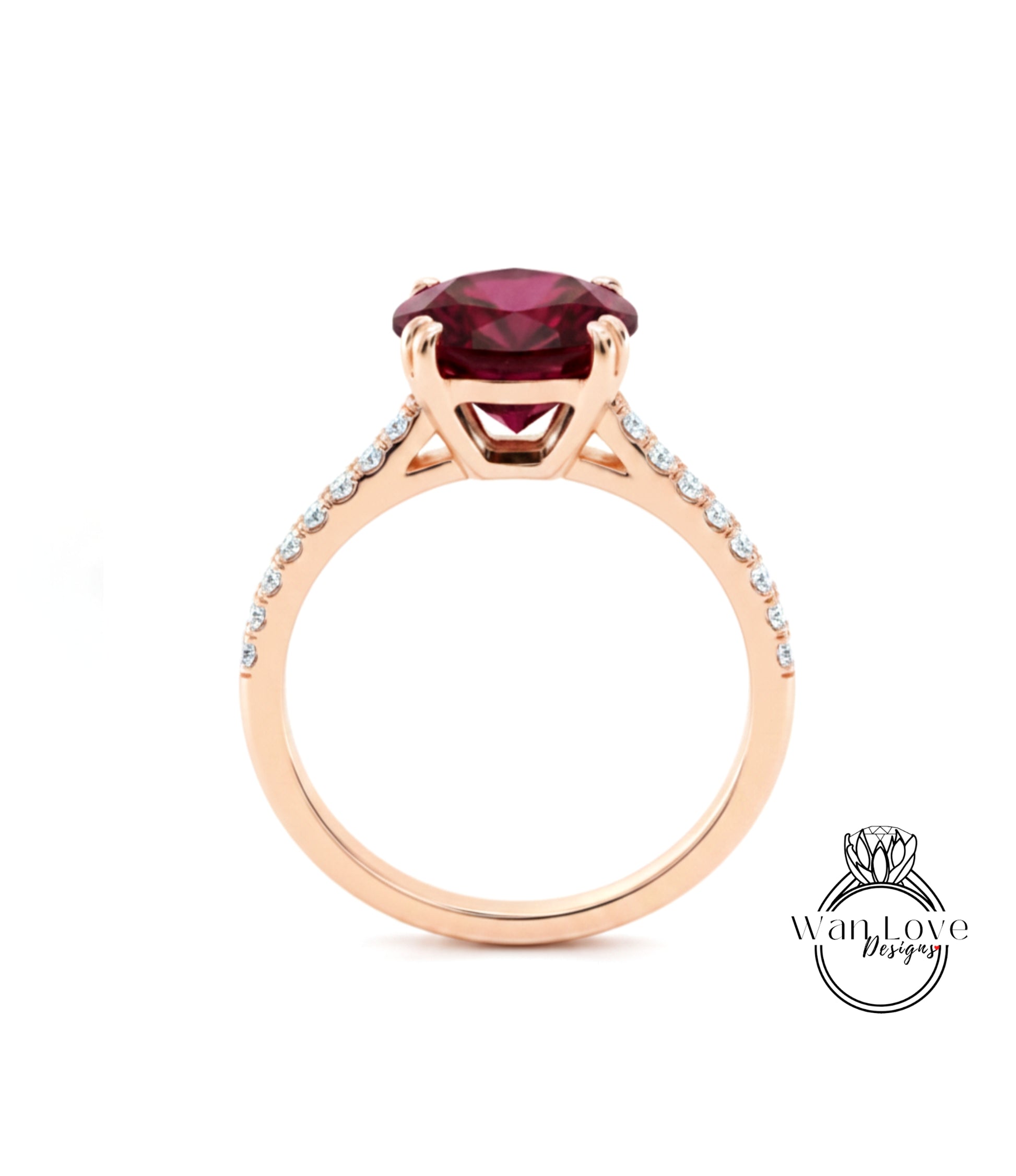 A gold ring with a large, deep red gemstone set in the center, surrounded by smaller diamonds.