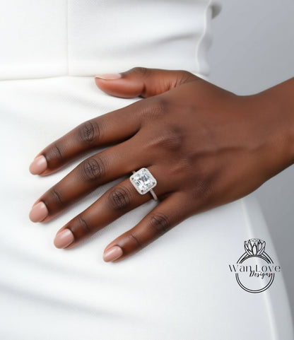 A close-up of a hand wearing a large diamond engagement ring.