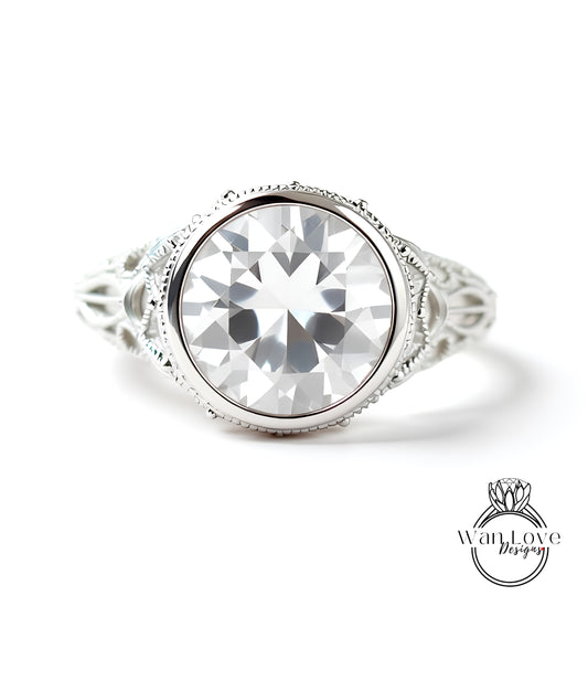 A close-up of a large, clear gemstone set in an ornate, silver-toned ring.