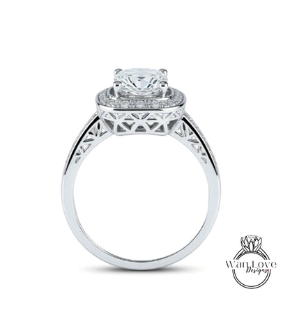 A silver engagement ring with a large central diamond surrounded by smaller diamonds, set in an intricate metal band.