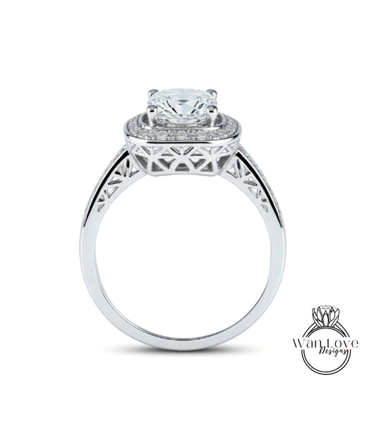 A silver engagement ring with a large central diamond surrounded by smaller diamonds, set in an intricate metal band.