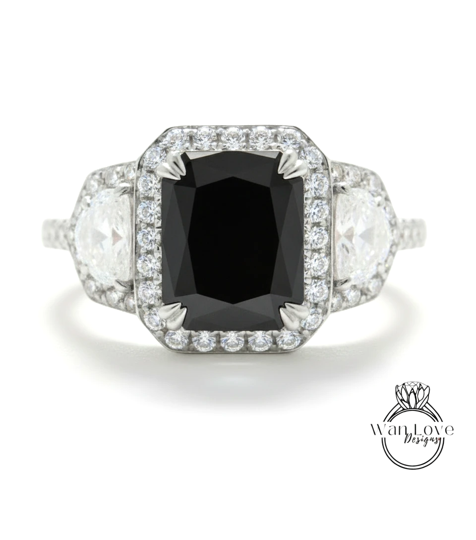 A diamond engagement ring with a large black diamond as the centerpiece, surrounded by smaller diamonds and set in a silver band.