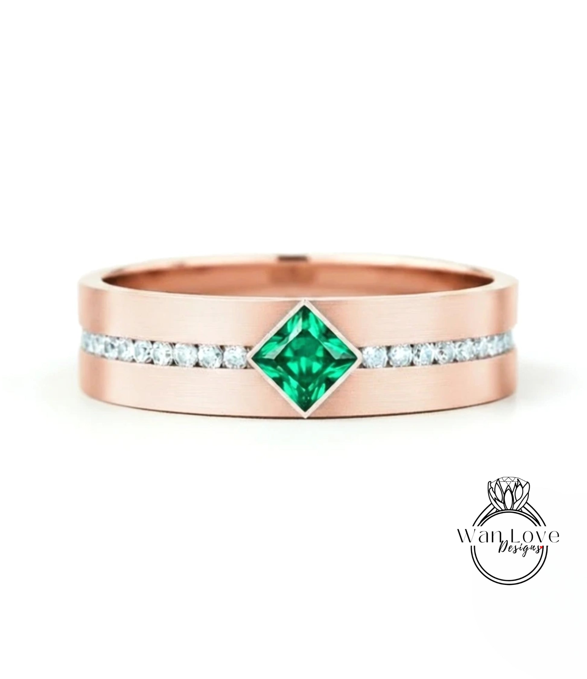 A rose gold ring with a large green gemstone in the center, surrounded by smaller diamonds.