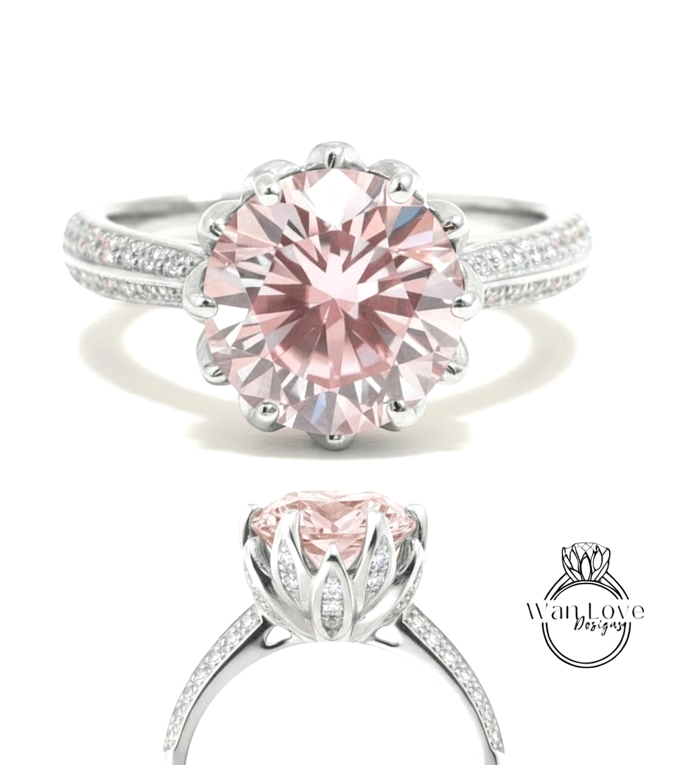 A stunning pink diamond engagement ring with a large central diamond surrounded by smaller diamonds on the band.