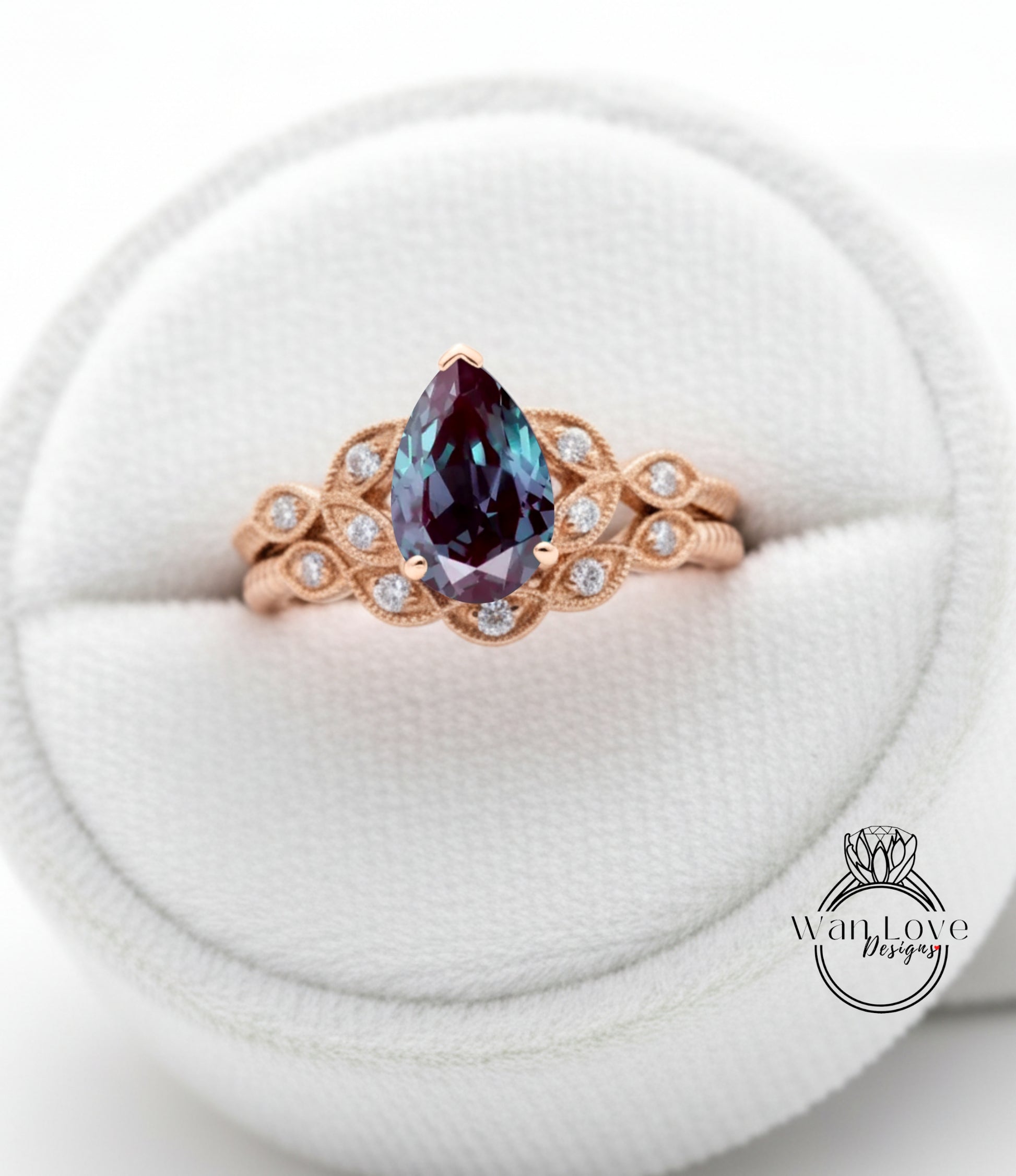 A close-up image of a gold ring with a large blue gemstone, placed in a white jewelry box.