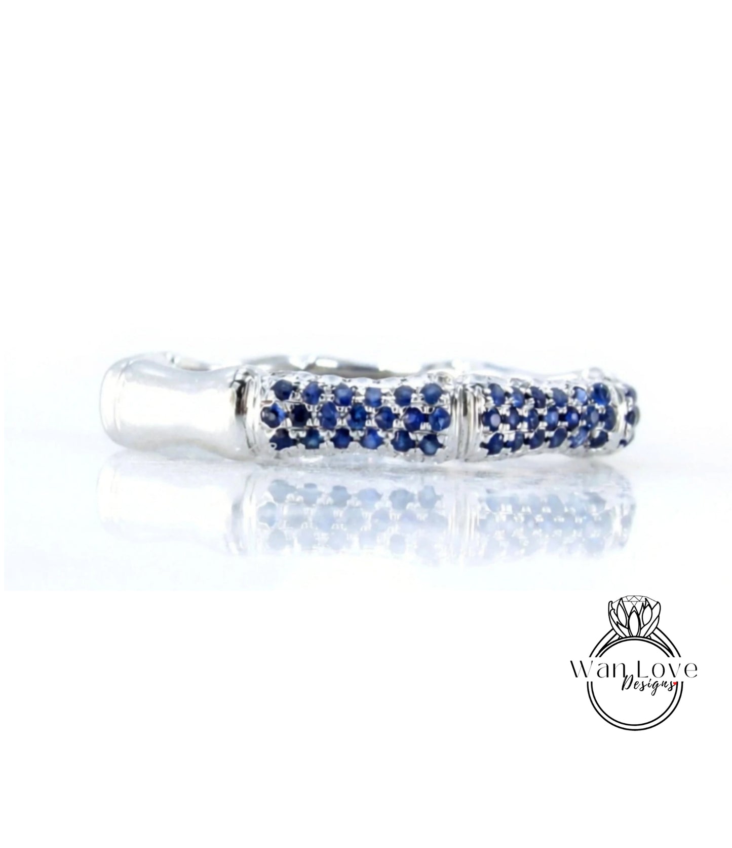 A silver ring with blue sapphires set in a decorative pattern.