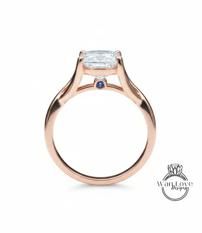 A rose gold engagement ring with a large round diamond set in the center, surrounded by smaller diamonds.