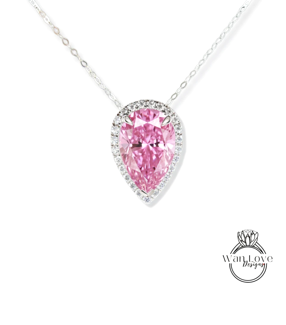 A necklace with a large, pink pear-shaped diamond set in a halo of smaller diamonds.