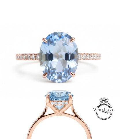A beautiful blue gemstone ring with a rose gold band and a small diamond accent.