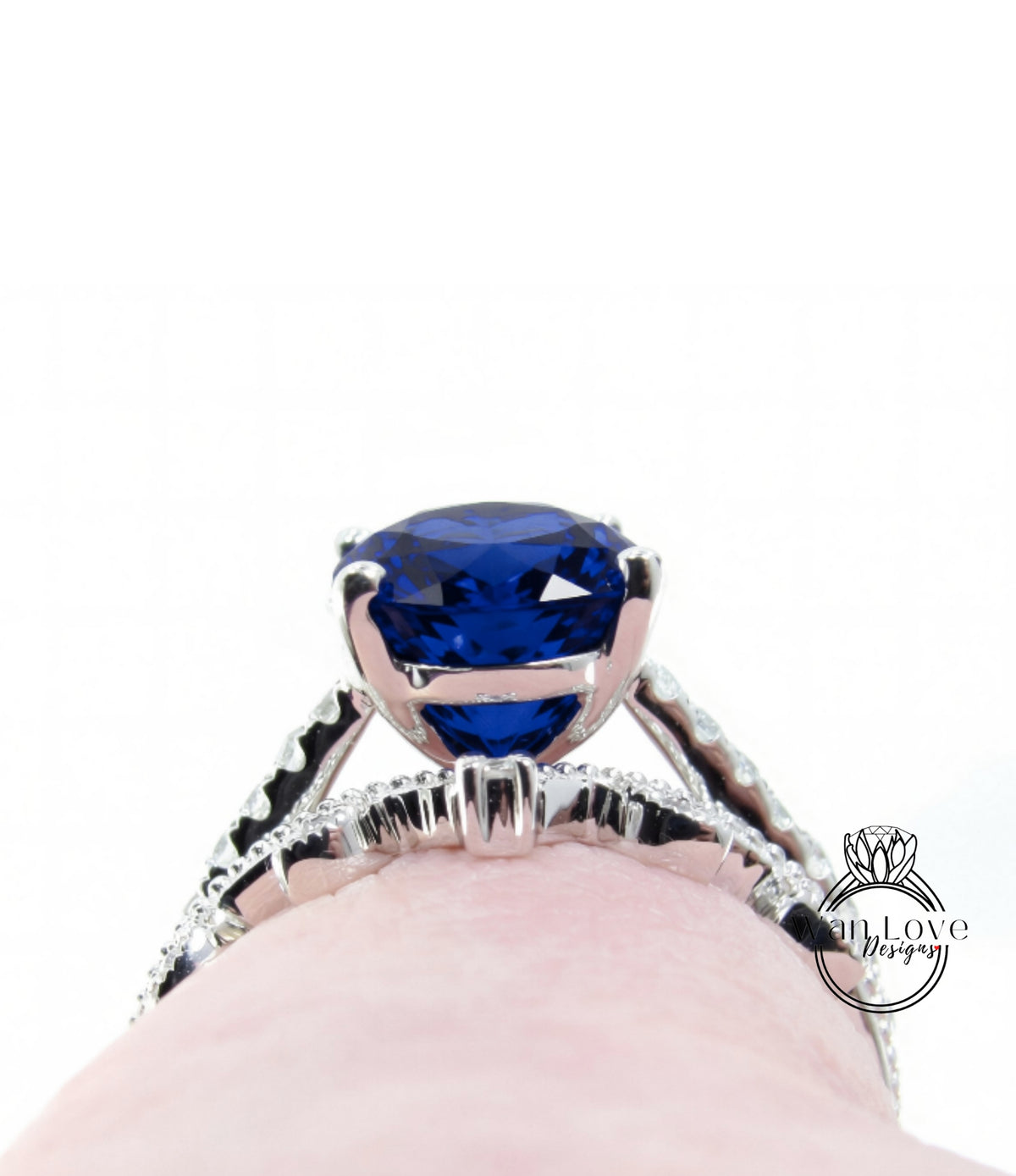 A close-up view of a diamond engagement ring with a large blue gemstone set in a silver band.