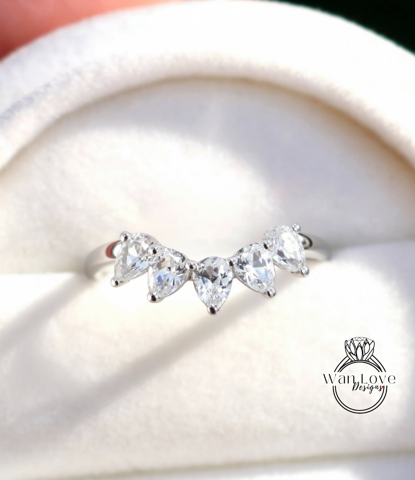 A close-up view of a diamond ring with a halo of smaller diamonds around the center stone.