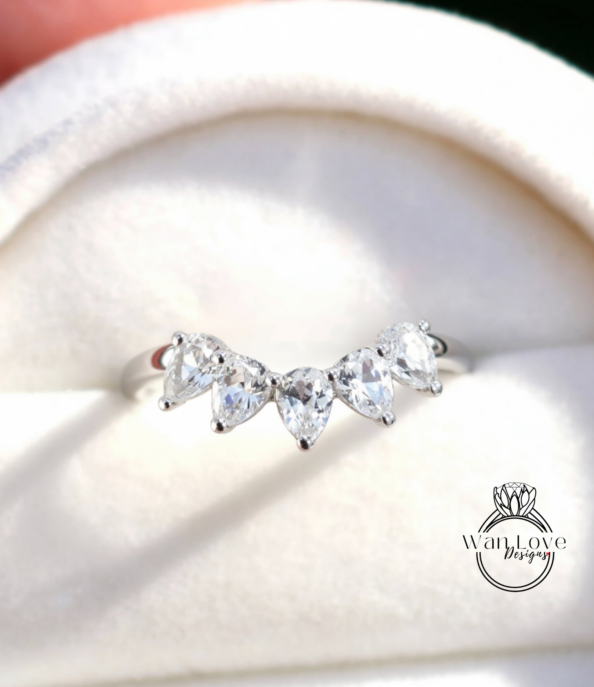 A close-up view of a diamond ring with a halo of smaller diamonds around the center stone.