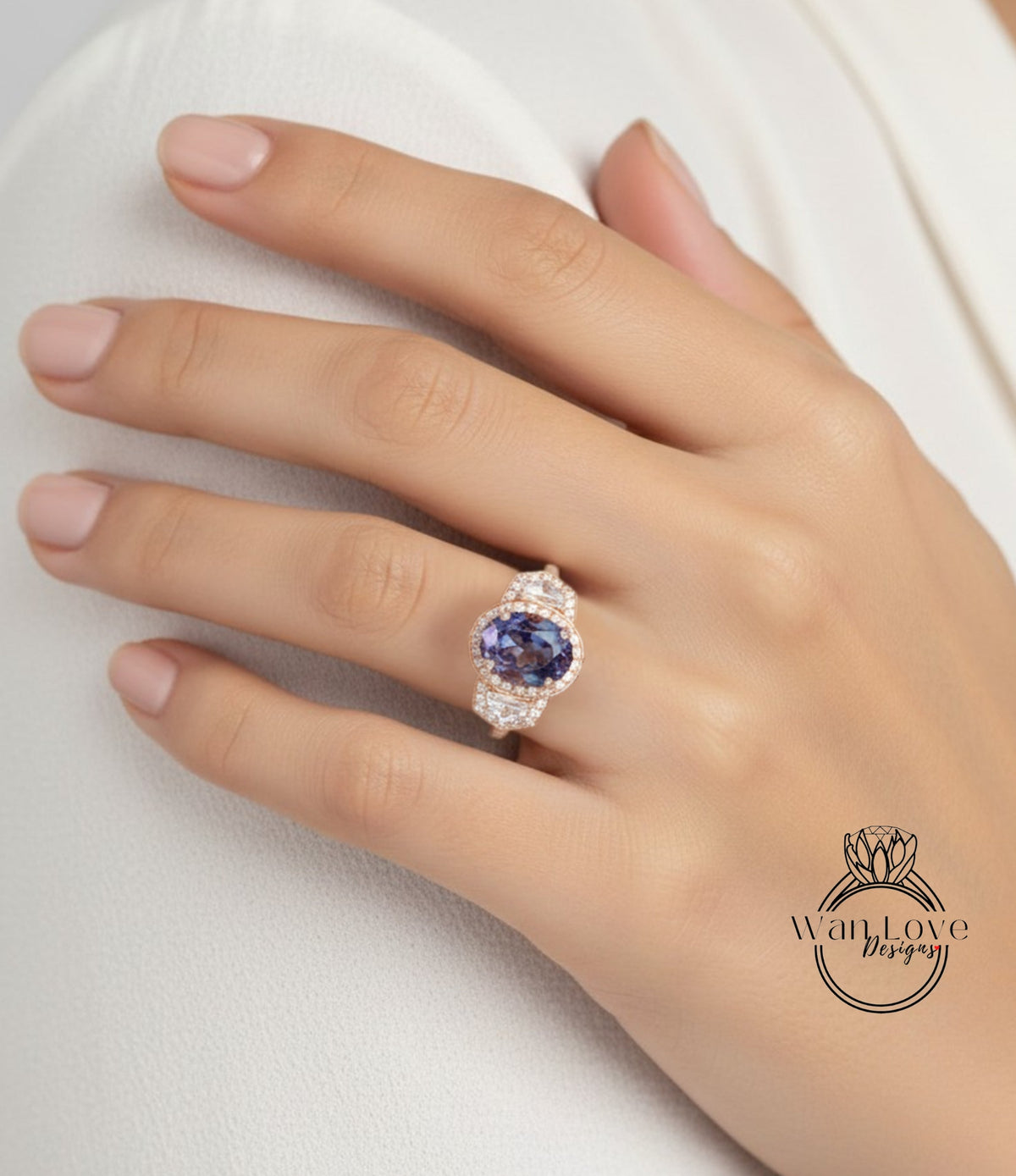 A close-up of a hand wearing a ring with a large oval-shaped gemstone, likely a sapphire, surrounded by smaller diamonds.