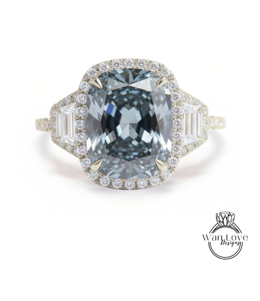 A stunning engagement ring with a large, blue diamond set in a halo of smaller diamonds, surrounded by a bezel of smaller diamonds.