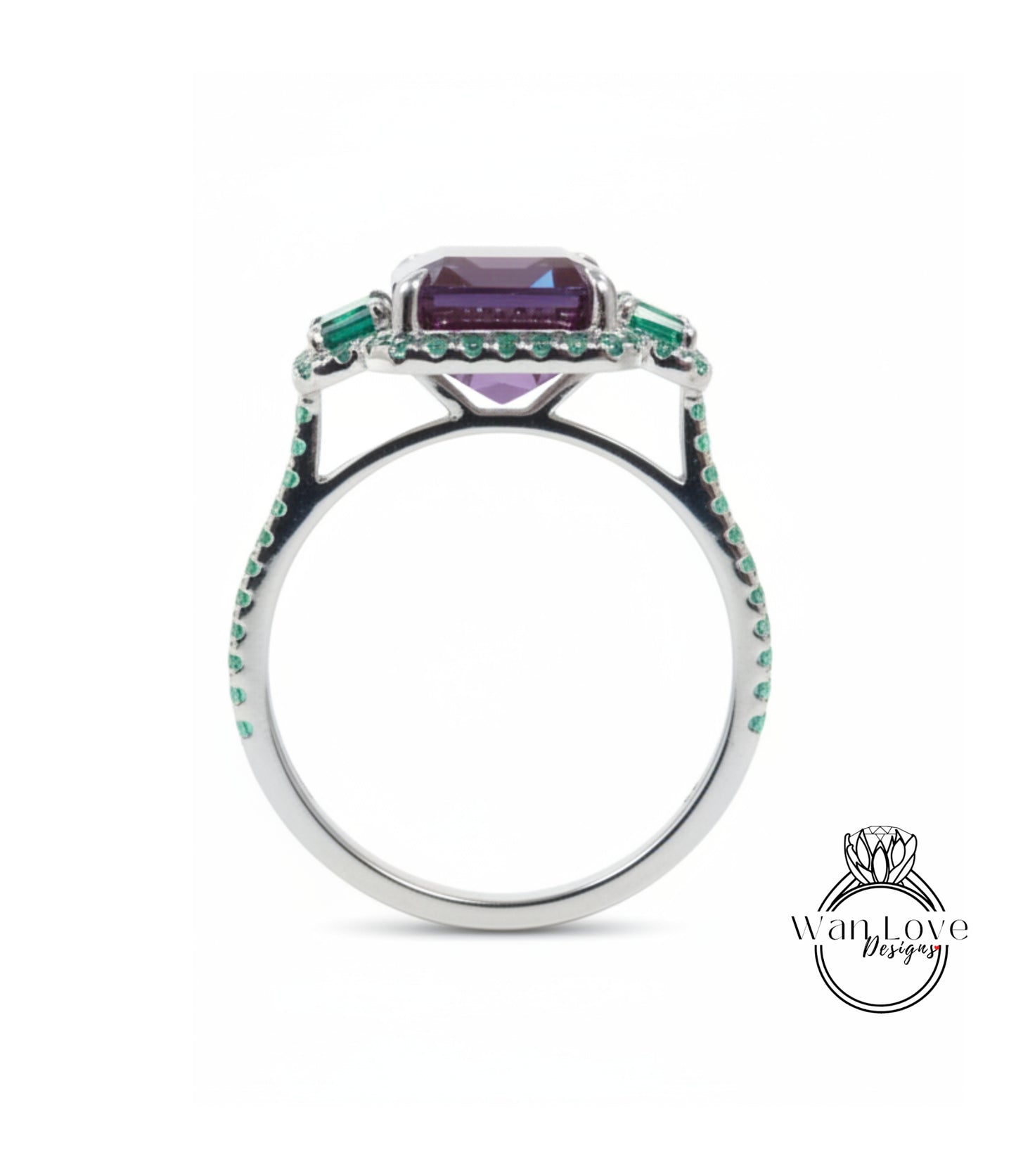 A silver ring with a large purple gemstone and green gemstones set in the center.