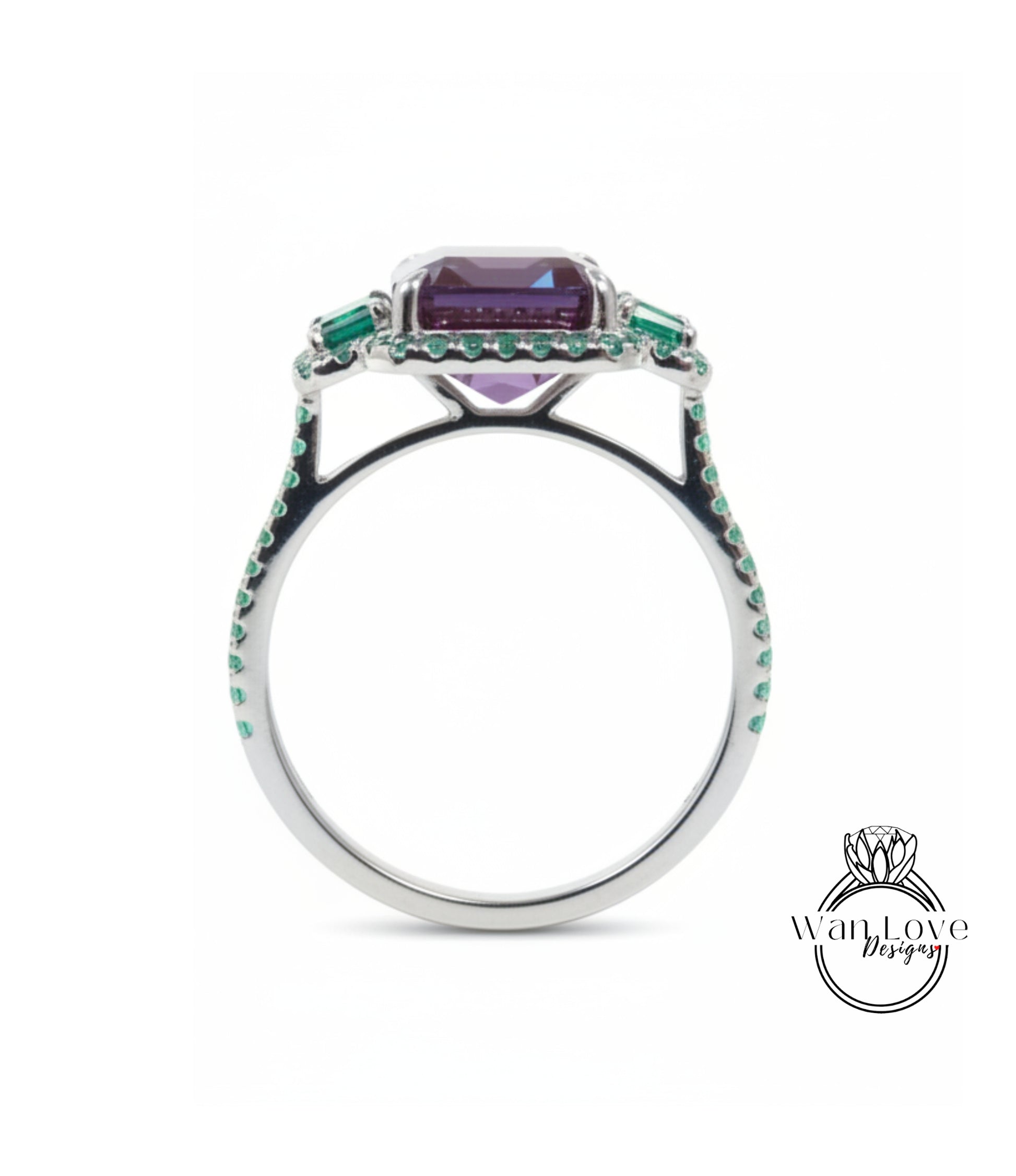 A silver ring with a large purple gemstone and green gemstones set in the center.