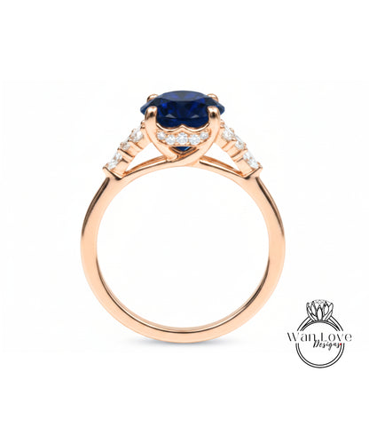 A gold ring with a large blue gemstone, possibly a sapphire, set in a halo of smaller diamonds.
