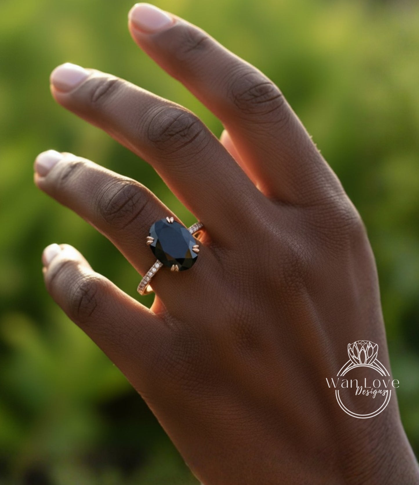 A close-up of a hand wearing a large black gemstone ring with a gold band.