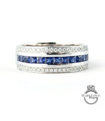 A silver ring with a row of blue sapphire gemstones set in a band.