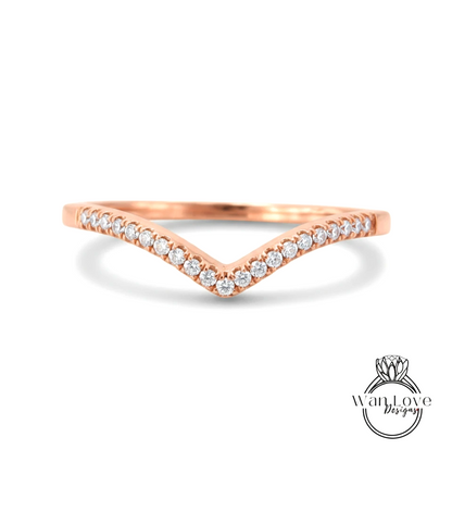 A rose gold ring with a v-shaped band and small diamonds set in it.