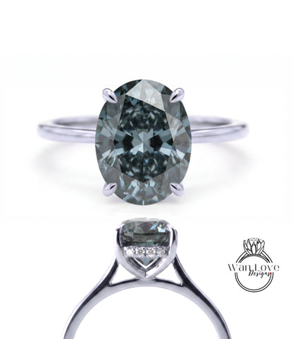 a silver ring with a large oval-shaped diamond as the centerpiece.