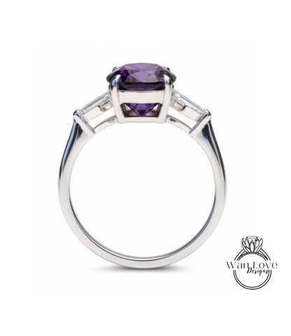 A silver ring with a large purple gemstone, possibly an amethyst, set in a three-stone design.