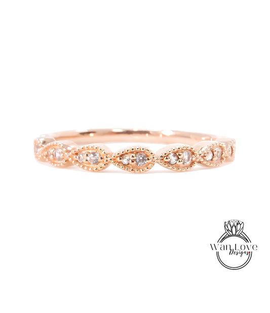 A rose gold ring with a row of small diamonds set in the center.